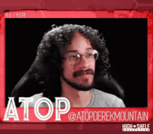 a picture of a man with curly hair and glasses with the name atop @ atopderekmountain