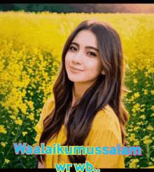 a woman in a yellow shirt stands in a field of yellow flowers