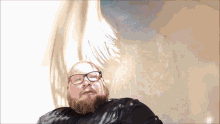 a bald man with glasses and a beard