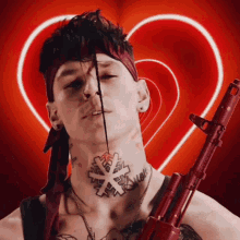 a man with a tattoo on his neck is holding a red gun