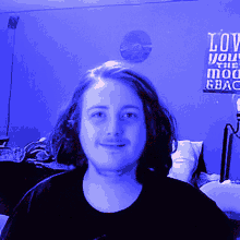 a man in front of a sign that says love you the moon and back