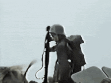 a man in a helmet holds a gun while sitting on a vehicle