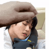 a pixelated image of a man sleeping with a stuffed animal on his chest