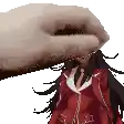 a hand is holding a doll in a red jacket over a white background .