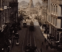 a black and white photo of a city street with the letters 24 ack on the bottom right