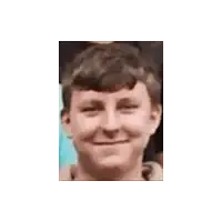a picture of a young boy with his eyes closed smiling
