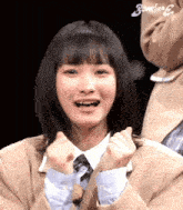 a close up of a girl 's face with the word bomber on the bottom right