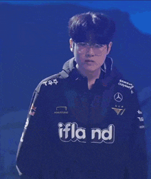 a man wearing a hoodie that says ifland