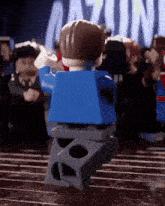a lego man in a blue shirt is standing in front of a sign that says ' gazino '