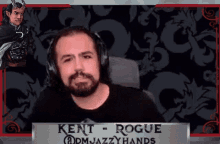 a man with a beard and horns is wearing headphones while sitting in front of a dragon .