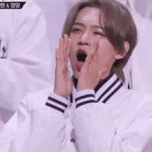 a man with his mouth open is wearing a white jacket with black stripes on the sleeves