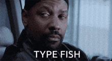 a man with a beard and a hat is sitting in a chair and says type fish .