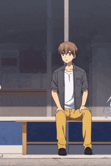 a man sits on a bench with his legs crossed