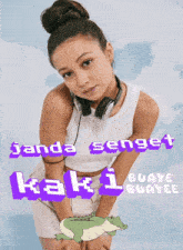 a woman wearing headphones stands in front of a blue sky with the words " janda senget kaki buaye buaye "