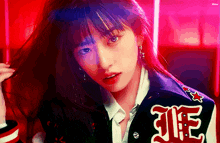 a woman wearing a varsity jacket with the word life on it .