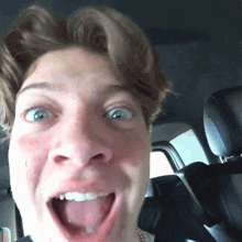 a close up of a man 's face with his tongue out