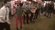 a group of men are playing guitars and dancing in a crowd