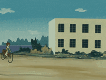 a person riding a bike in front of a building with mountains in the background