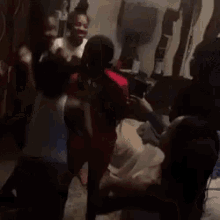 a group of people are kneeling on the floor in a room .