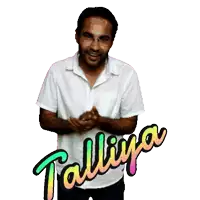 a man in a white shirt stands in front of a talliya sign