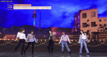 a group of women are dancing in front of a building with the words secret number written on it