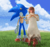 a woman kneeling next to a sonic the hedgehog in a grassy field