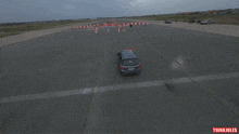 an aerial view of a car driving on a road with thinki jules written on the bottom right