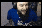 a man with a beard is wearing headphones and a shirt that says justice worldwide