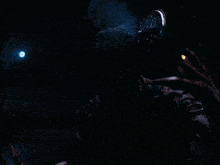 a man with a bloody face is holding a light in his hand