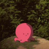 a pink octopus is sitting on a rock in front of a forest