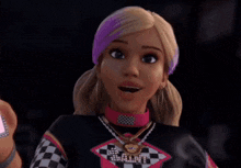 a barbie doll is holding a cell phone and looking at it .