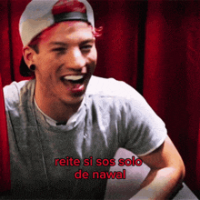 a man with red hair is laughing with the words " reitere si sos solo de nawal " below him