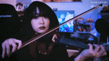 a woman playing a violin with the name luna lorraine on the bottom left