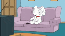 a cartoon cat is sitting on a couch watching tv