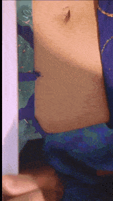 a close up of a woman 's stomach with a ring on it