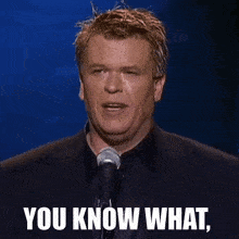 a man speaking into a microphone with the words " you know what " written below him