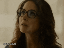 a close up of a woman wearing glasses with the hashtag lialmeida05 on the bottom