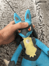 a person is holding a stuffed animal with a yellow shirt on