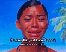 a woman is crying on a beach with the words `` if i send this just know i don 't wanna do that ''