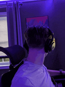 a man wearing headphones is sitting in a chair