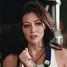 a woman wearing a white tank top has a strap that says vero velvet