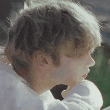 a close up of a person 's face with a sweater on