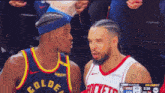 two basketball players from the golden state warriors and the rockets are talking