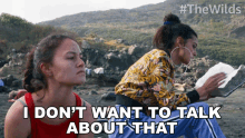 two women sitting on a beach with the words " i don 't want to talk about that " below them