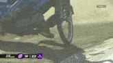a close up of a person riding a motorcycle on a dirt track with the number 19 on the screen