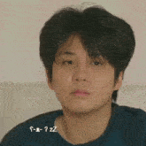 a close up of a young man 's face with the words s-e-z-z written below it