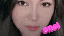 a close up of a woman 's face with a pink sticker that says one .
