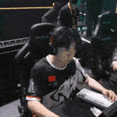 a man wearing headphones is sitting in a chair that says anda on it