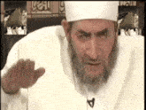a man with a beard is wearing a white hat and a necklace with the letter a on it
