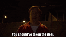 a man in a red jacket is saying " you should 've taken the deal "